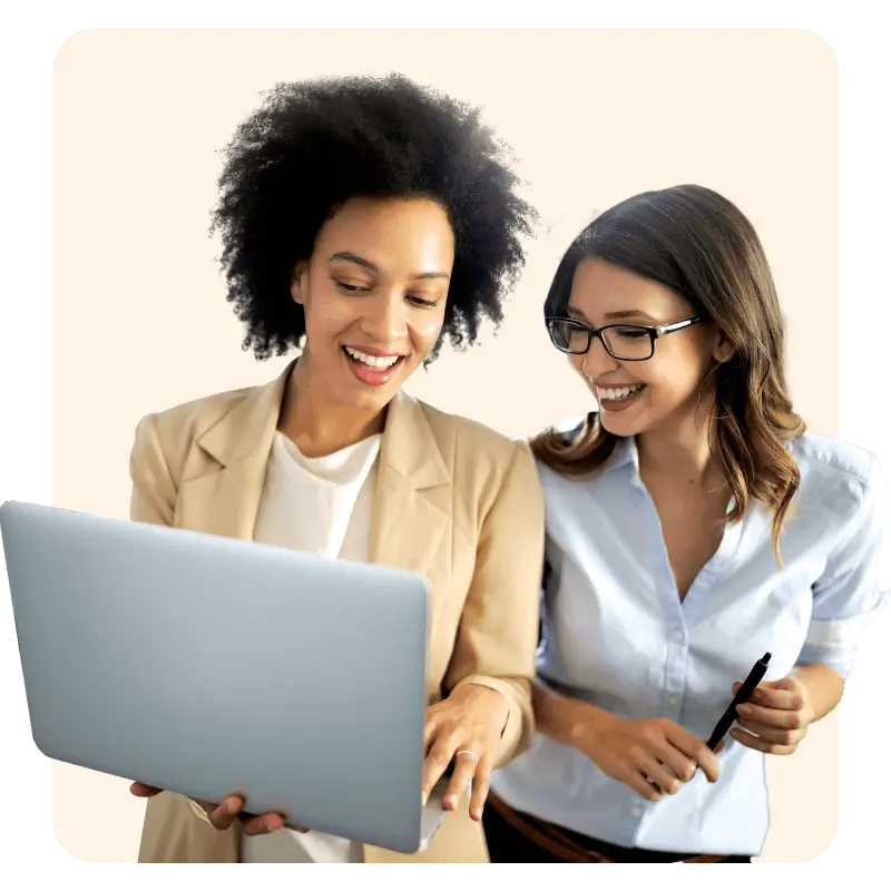 Two friends looking at a laptop, one showing the other to refer to church pharmacy 